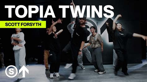 The word “topia” is actually a synonym, often used as a suffix, for a geographical region. You will notice that the title of the album this track (“Topia Twins”) …